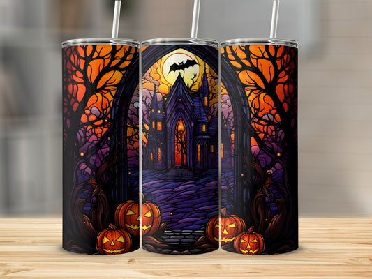 Halloween tumbler with haunted castle and pumpkins.