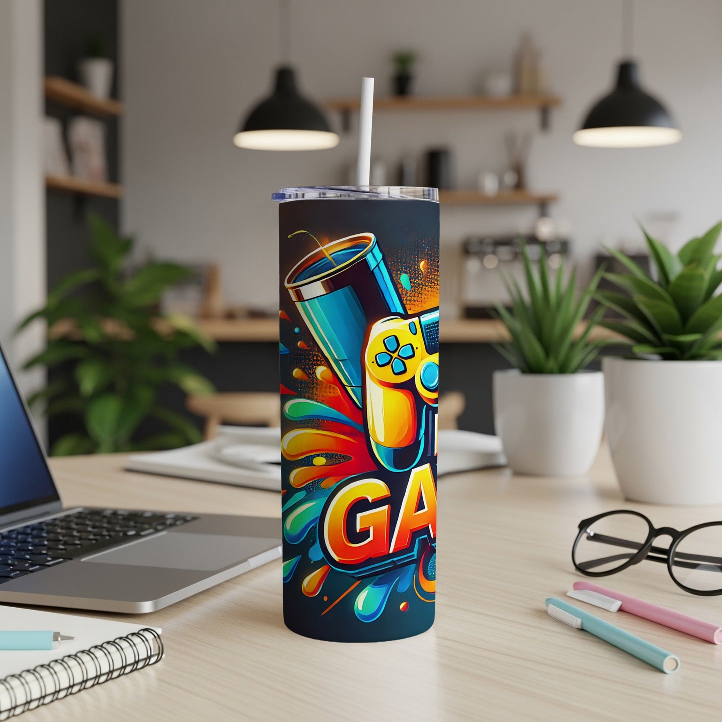 Gaming controller and vibrant splash art on a tall tumbler with a straw.