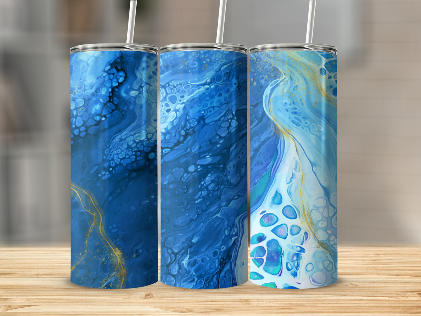 Three tumblers with abstract blue and gold fluid art designs.