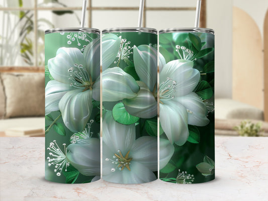 Three green tumblers with white floral designs and straws.