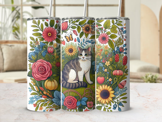 Tabby cat surrounded by colorful floral designs, butterflies, and pumpkins on a tumbler.
