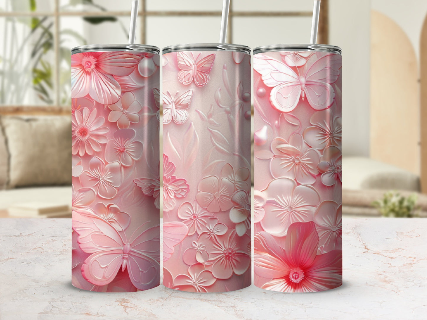 Pink floral and butterfly patterned tumbler with a straw.