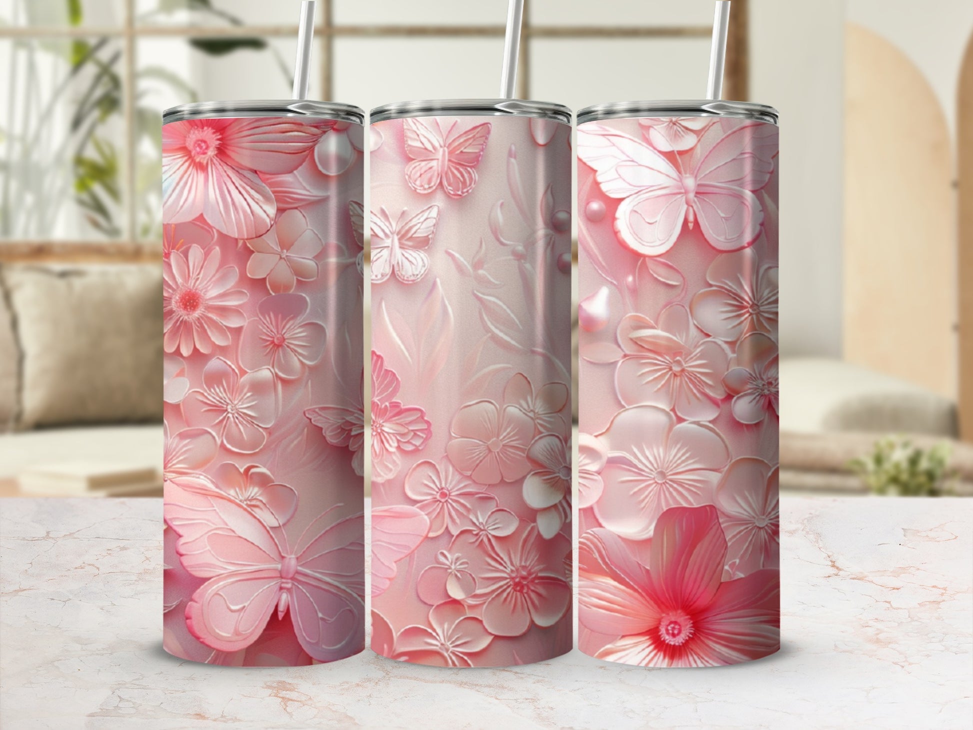 Pink floral and butterfly patterned tumbler with a straw.