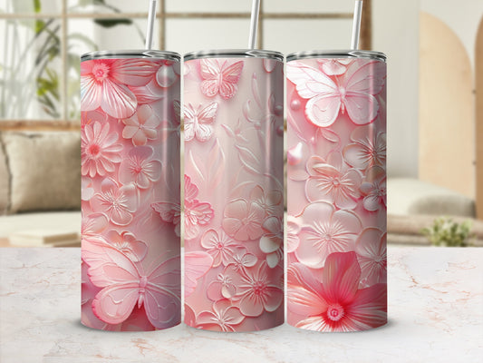 Pink floral and butterfly patterned tumbler with a straw.