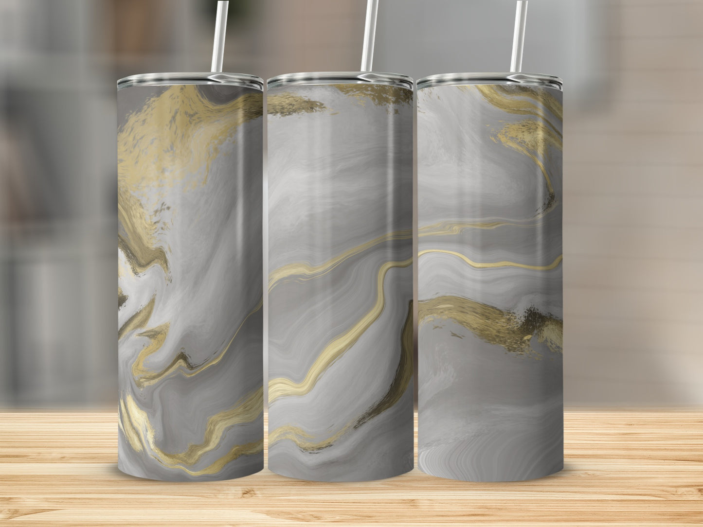 Three tall tumblers with a gray and gold abstract marble design.
