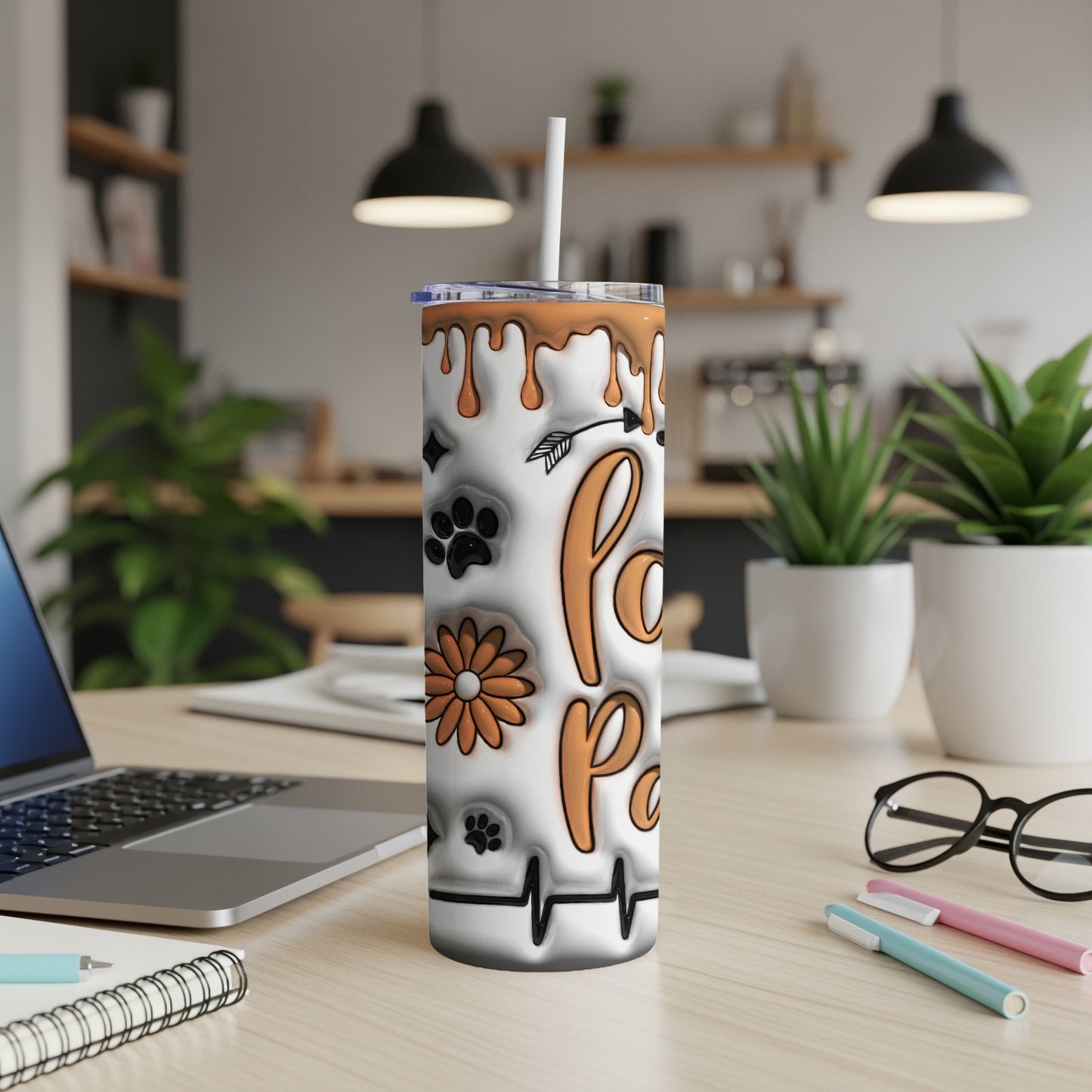 Orange paw print tumbler with floral and heartbeat designs.