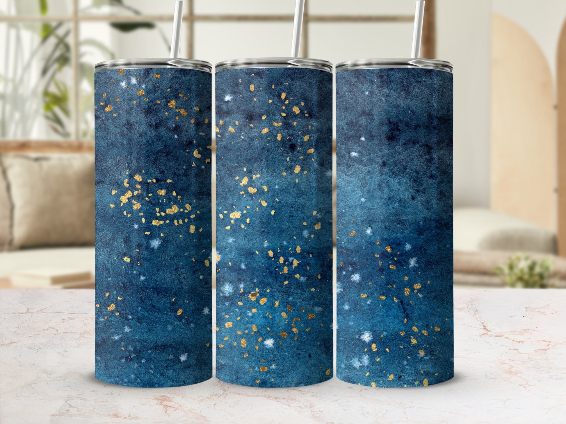 Three tumblers with a dark blue and gold speckled watercolor design.