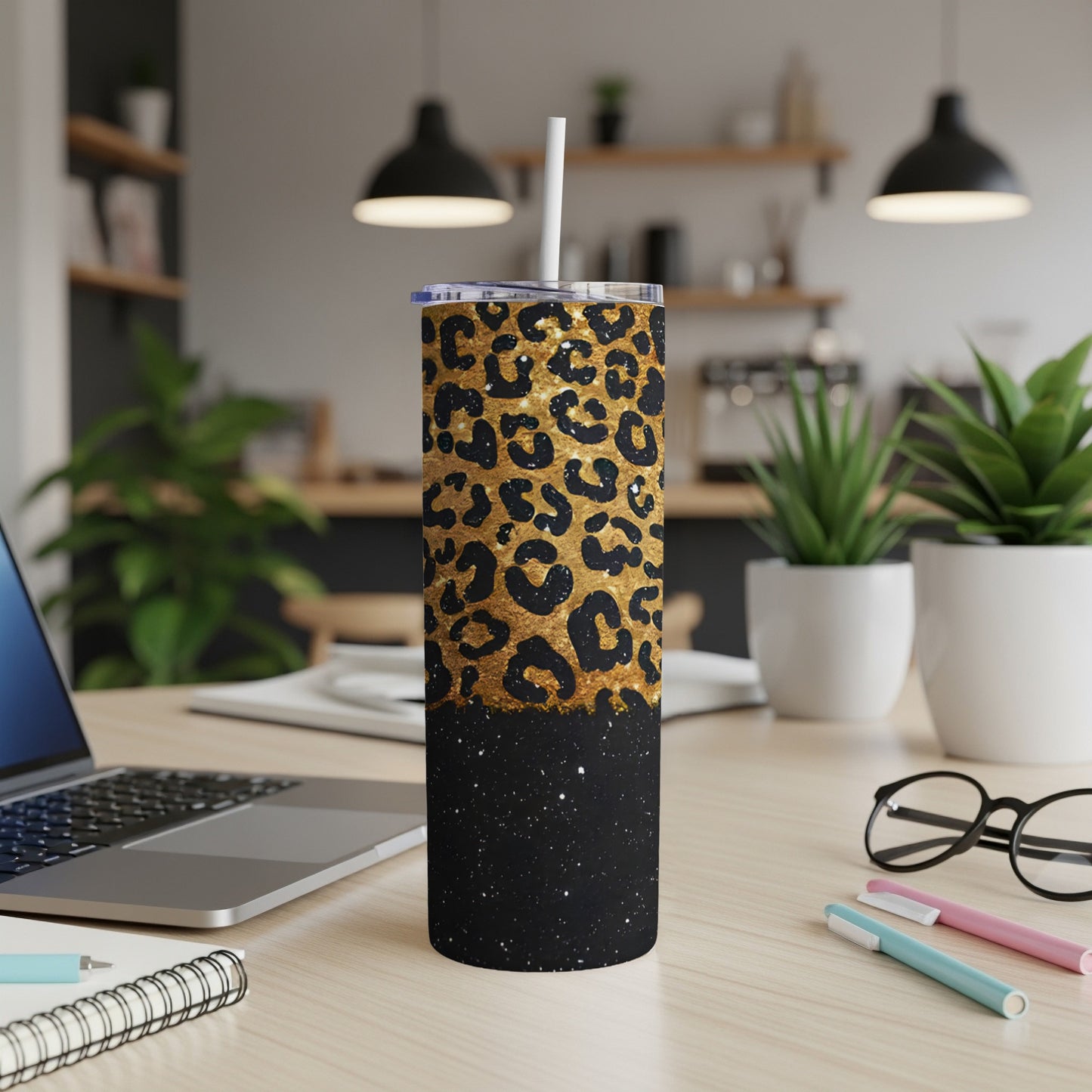 Black tumbler with gold leopard print and glitter base.