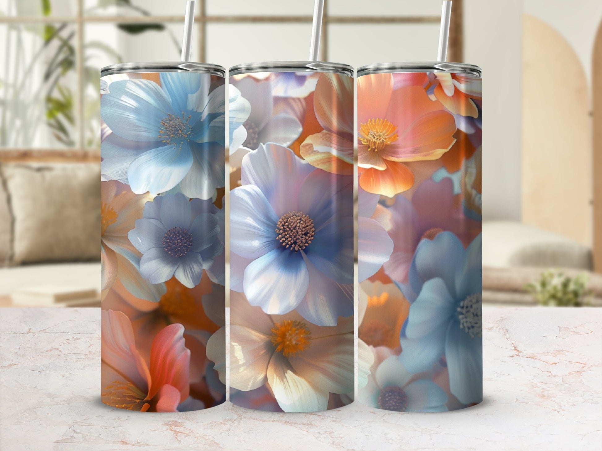 Three tumblers with floral watercolor designs in blue, white, and orange.