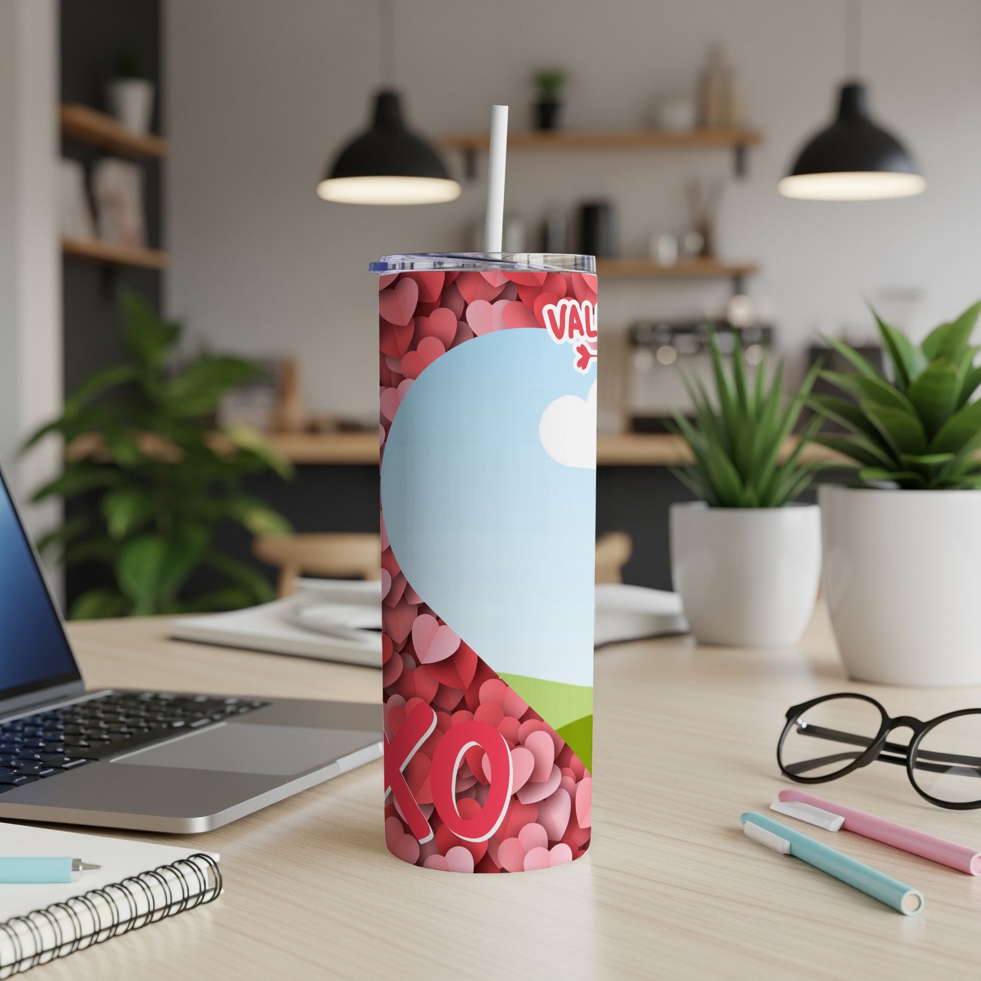 Valentine's Day tumbler with heart pattern and "XO" text on a desk.
