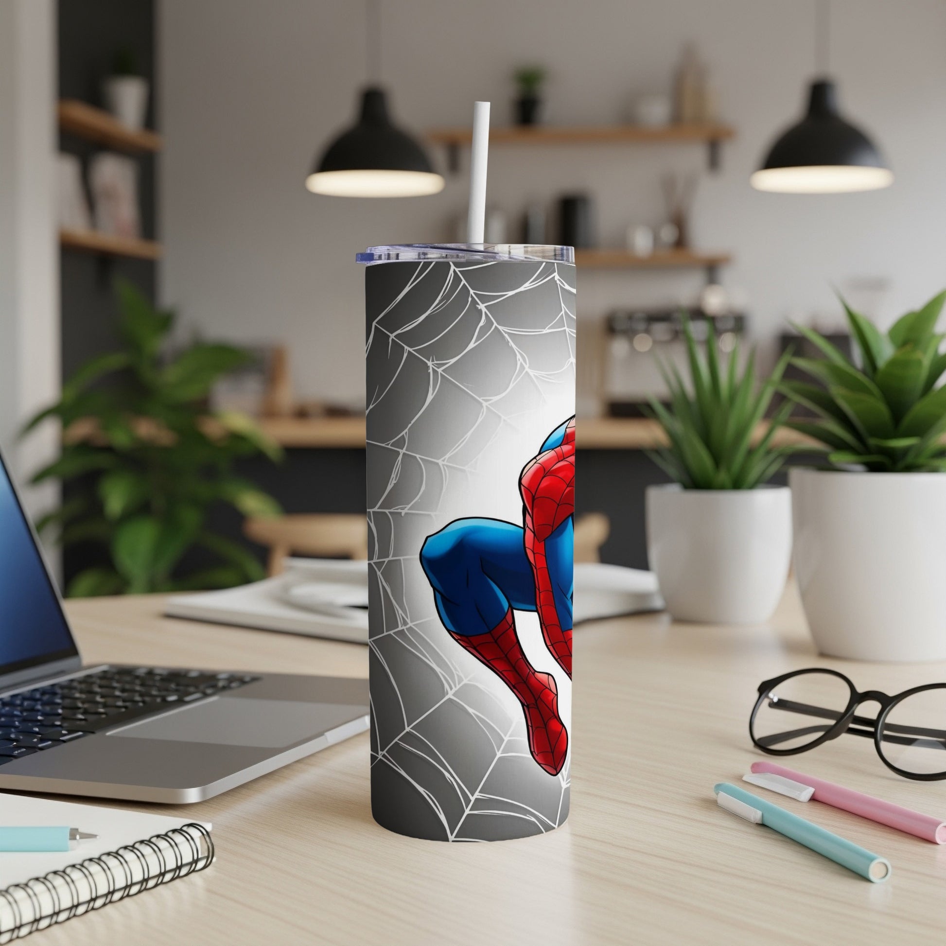 Spider-Man on a silver web pattern tumbler with a straw.