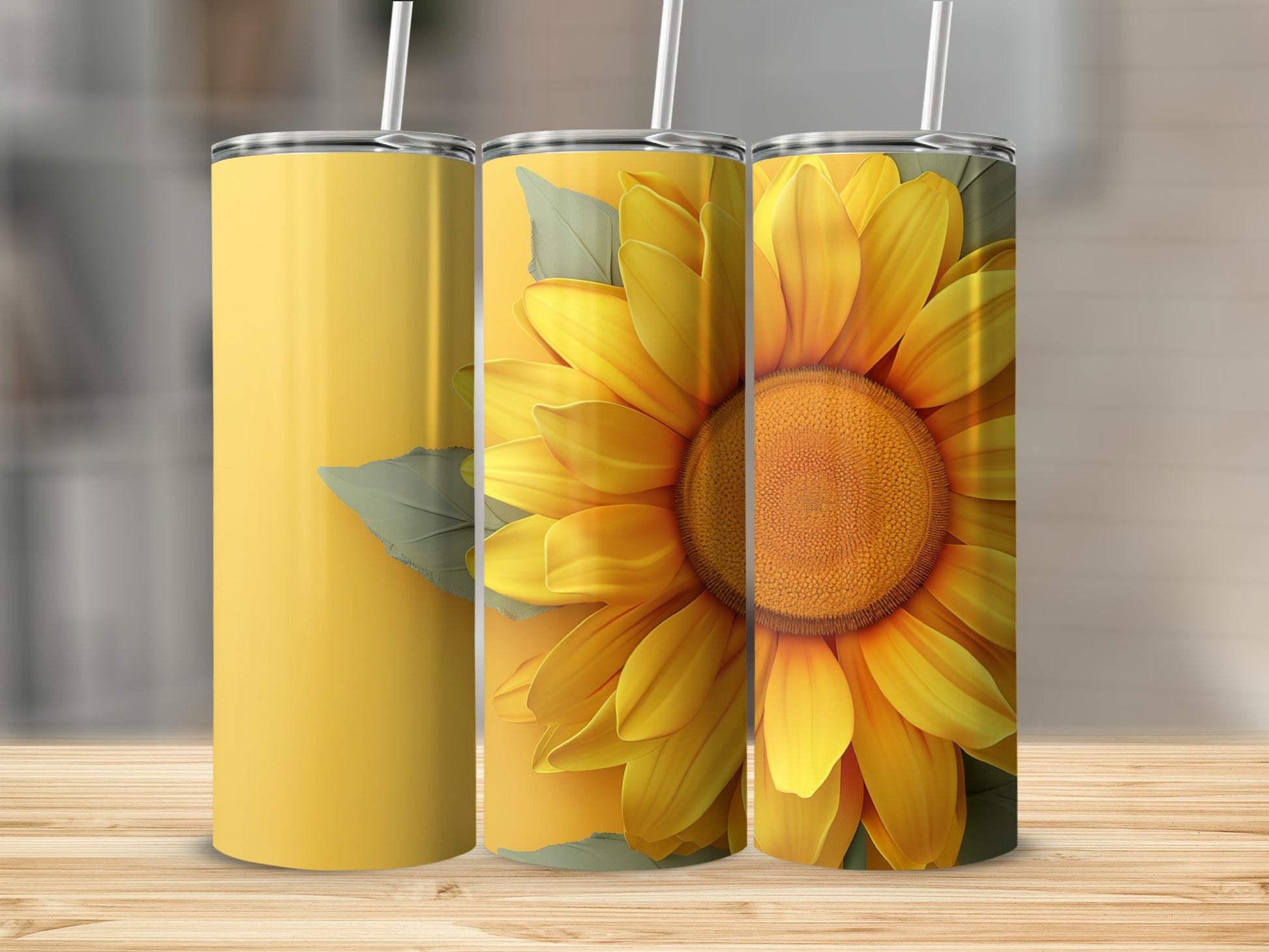 Three tumblers, one plain yellow, two with a large sunflower design.