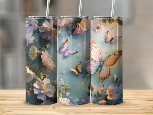 Three tumblers with floral and butterfly designs on a wooden surface.