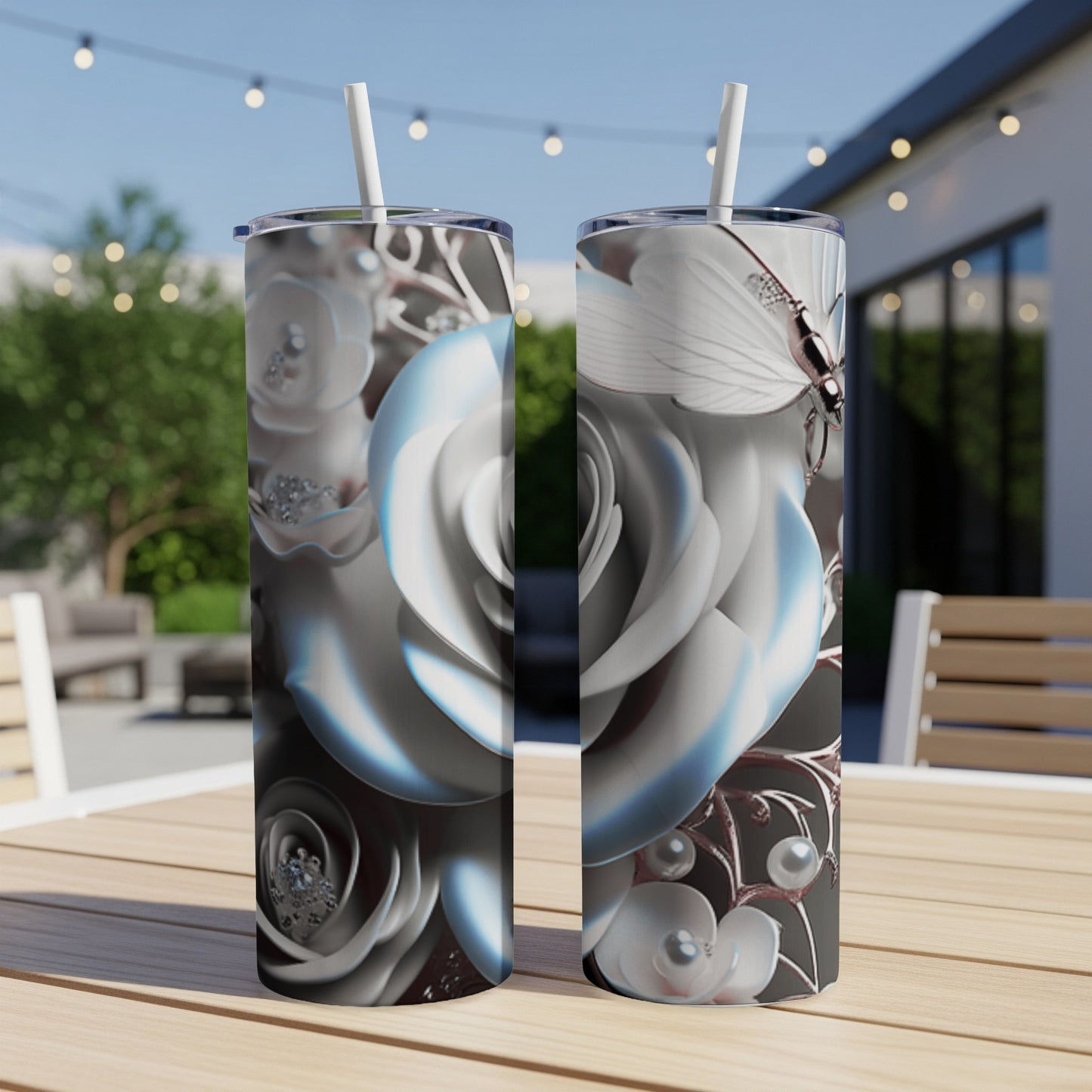 Two white roses with pearl and butterfly embellishments on tumblers.