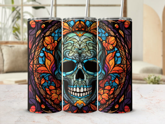 Three tumblers with a stained-glass skull design in vibrant blues, oranges, and purples.