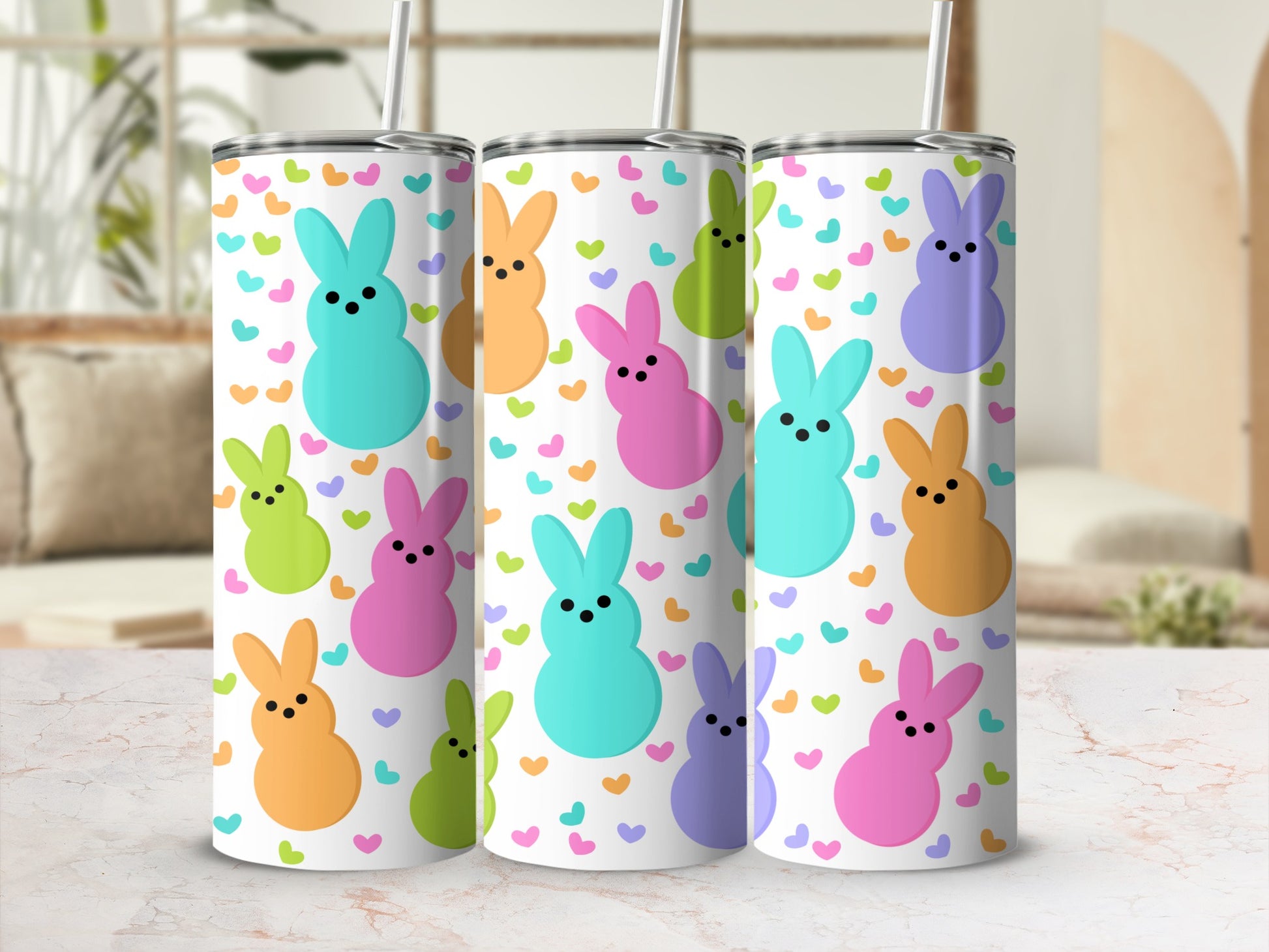 White tumbler with colorful bunny shapes and small hearts.