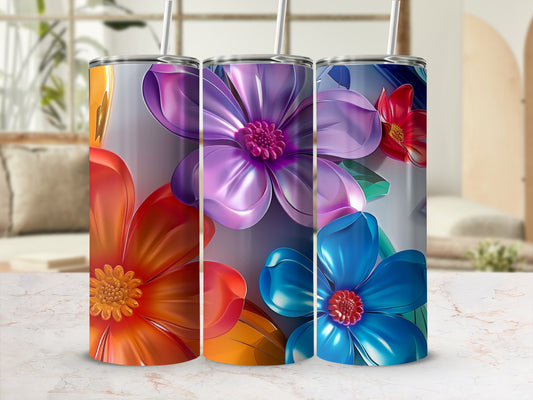 Three tumblers with colorful floral designs and patterned backgrounds.