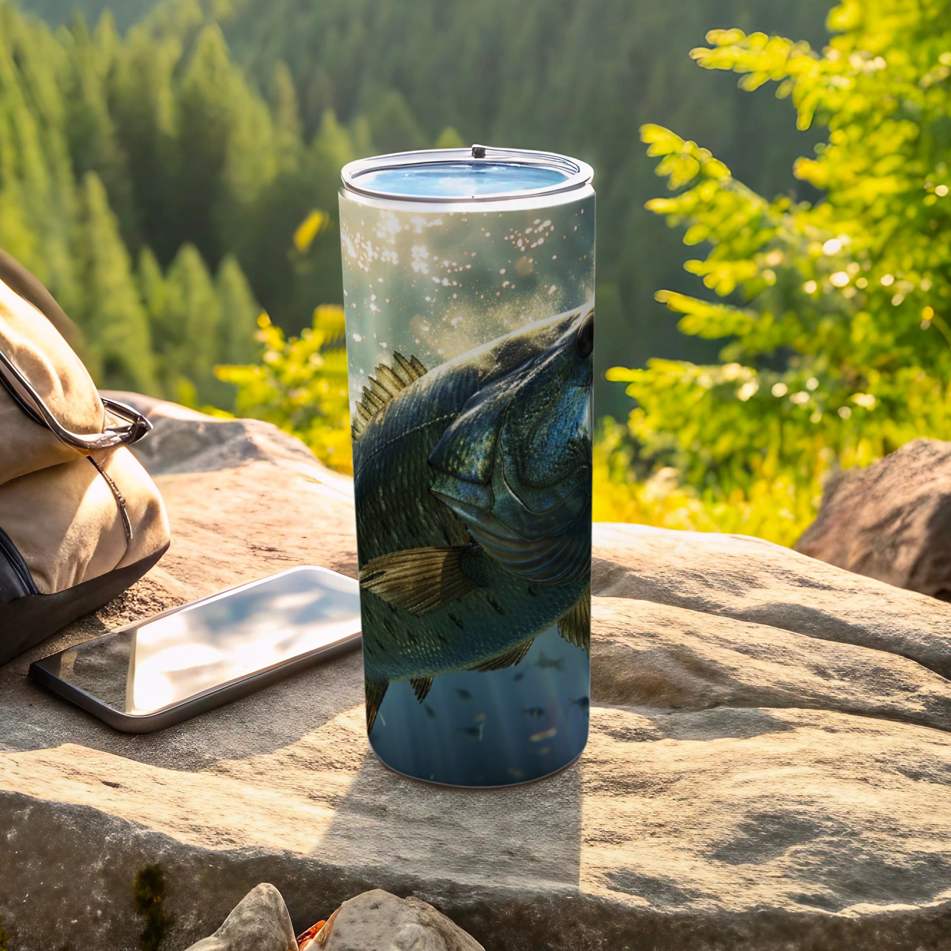Fish on a tumbler with a forest background and a cell phone.