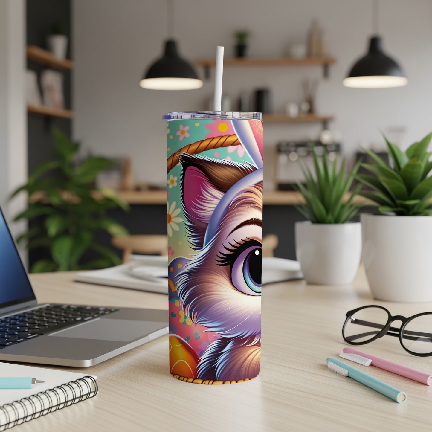 Colorful Easter bunny tumbler with straw on a desk.