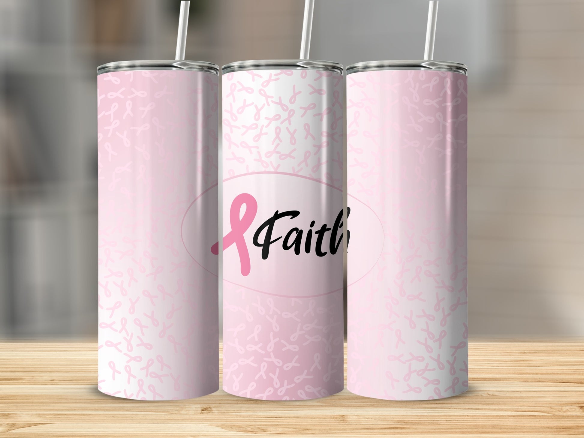 Pink ribbon pattern tumbler with "Faith" text on a wooden surface.