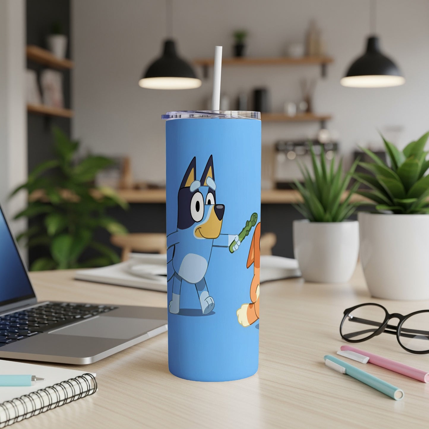 Bluey and Bingo characters on a blue tumbler with straw.