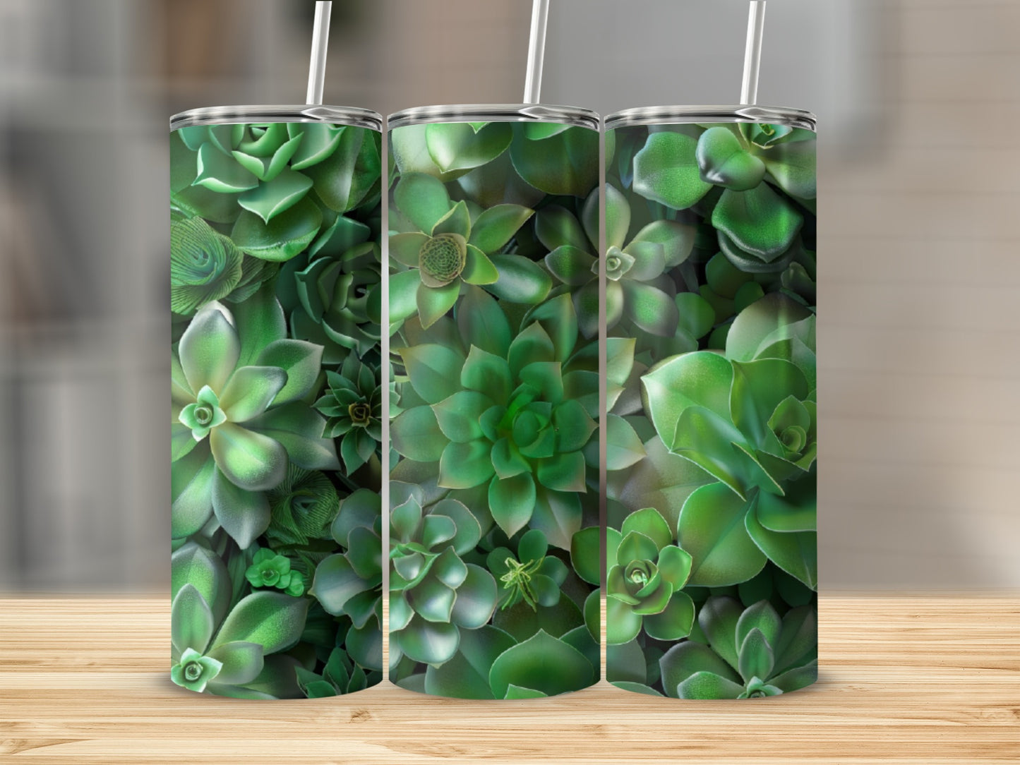 Three green succulent tumblers with straws on a wooden surface.