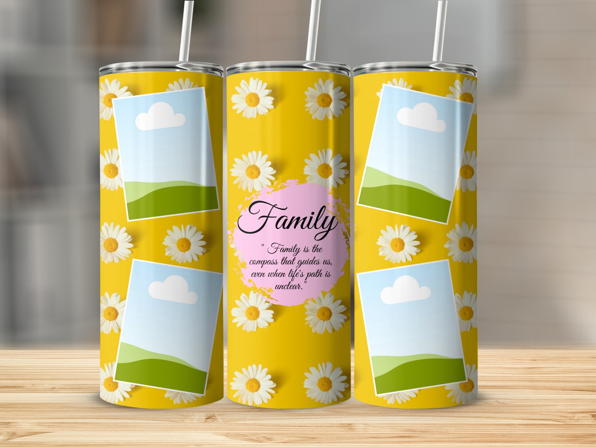 Yellow tumbler with daisies, picture frames, and "Family is the compass" quote.