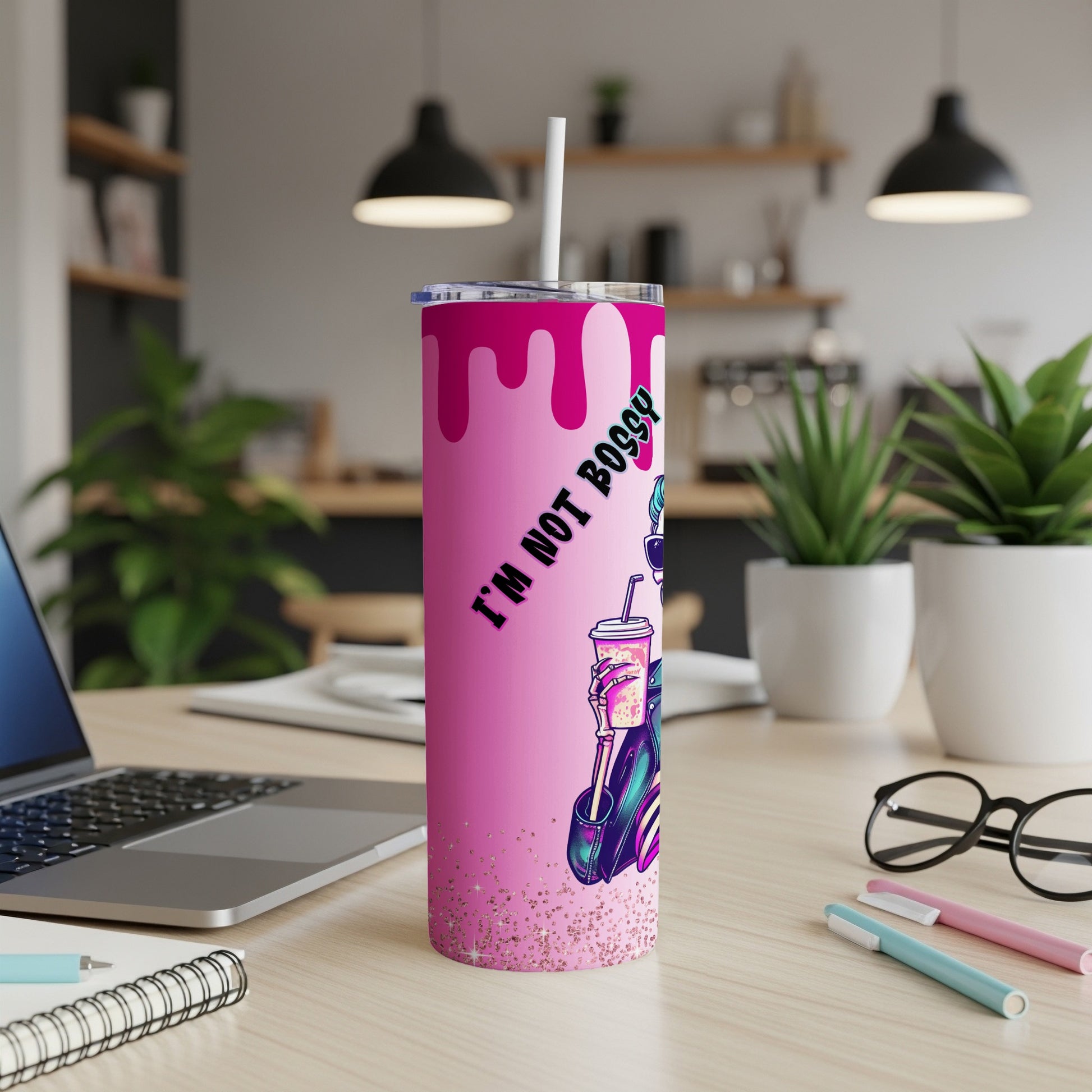 Pink tumbler with "I'M NOT BOSSY" text and illustrated character drinking a beverage.