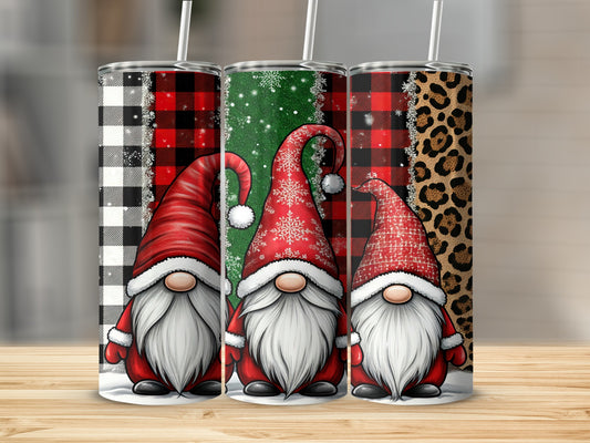 Three gnomes in red hats with holiday patterns on tumblers.