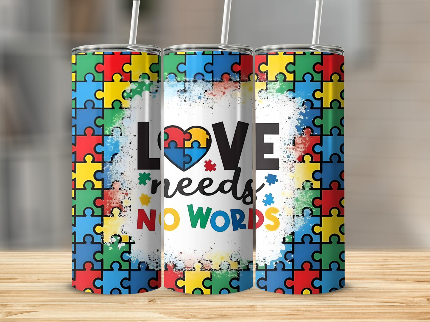 Autism awareness tumbler with "LOVE needs NO WORDS" text and puzzle pieces.