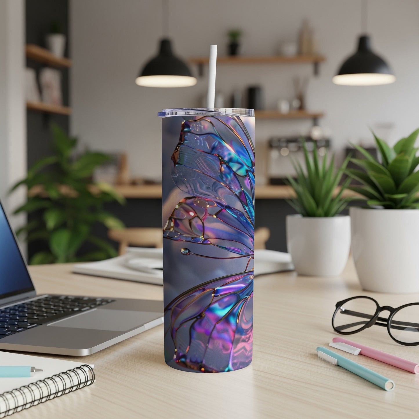 Iridescent butterfly wing design on a tall, insulated tumbler with a straw.