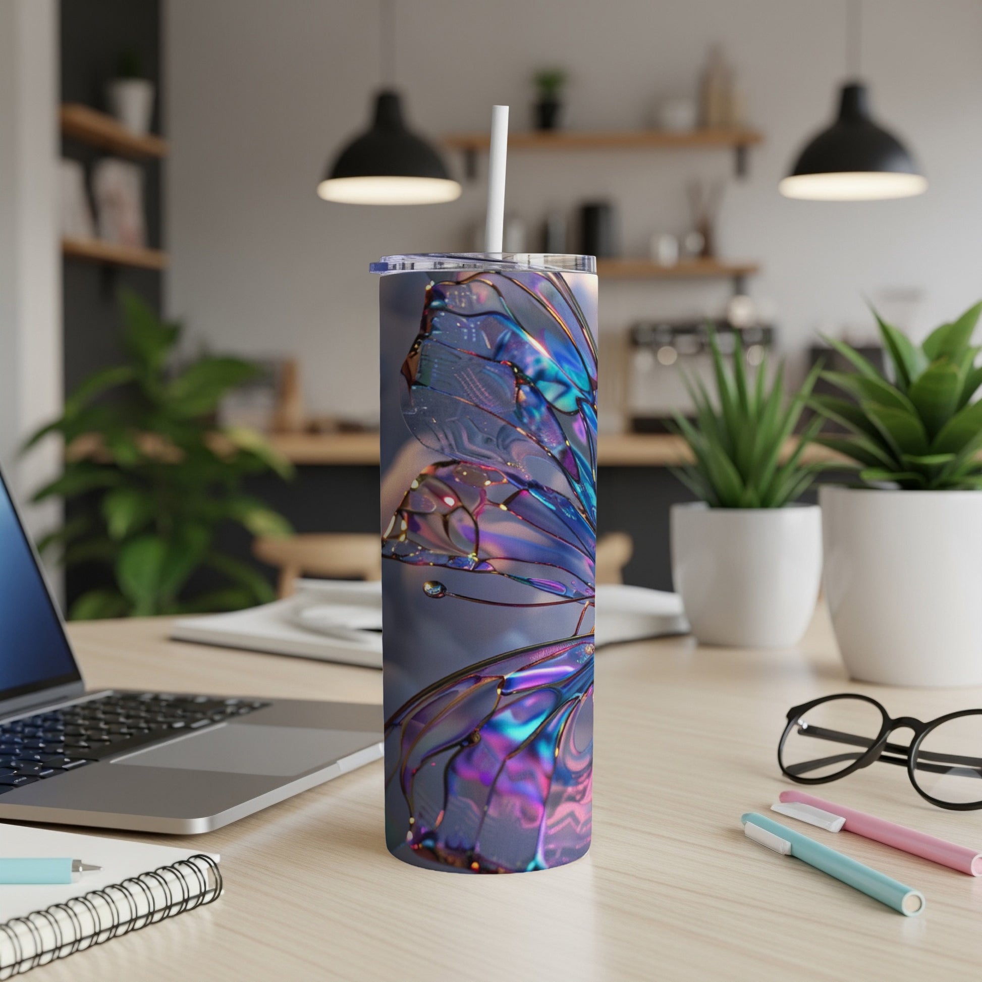 Iridescent butterfly wing design on a tall, insulated tumbler with a straw.
