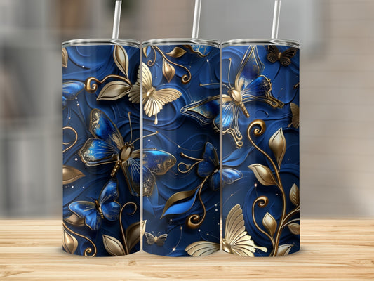 Blue tumbler with golden butterflies and floral accents.