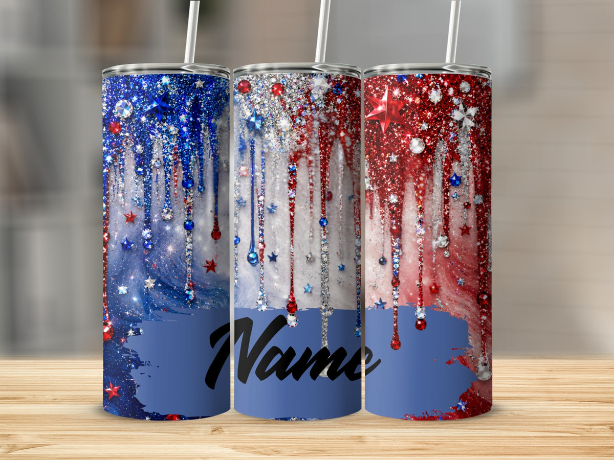 Three patriotic tumblers with glitter, gems, and stars on a wooden surface.