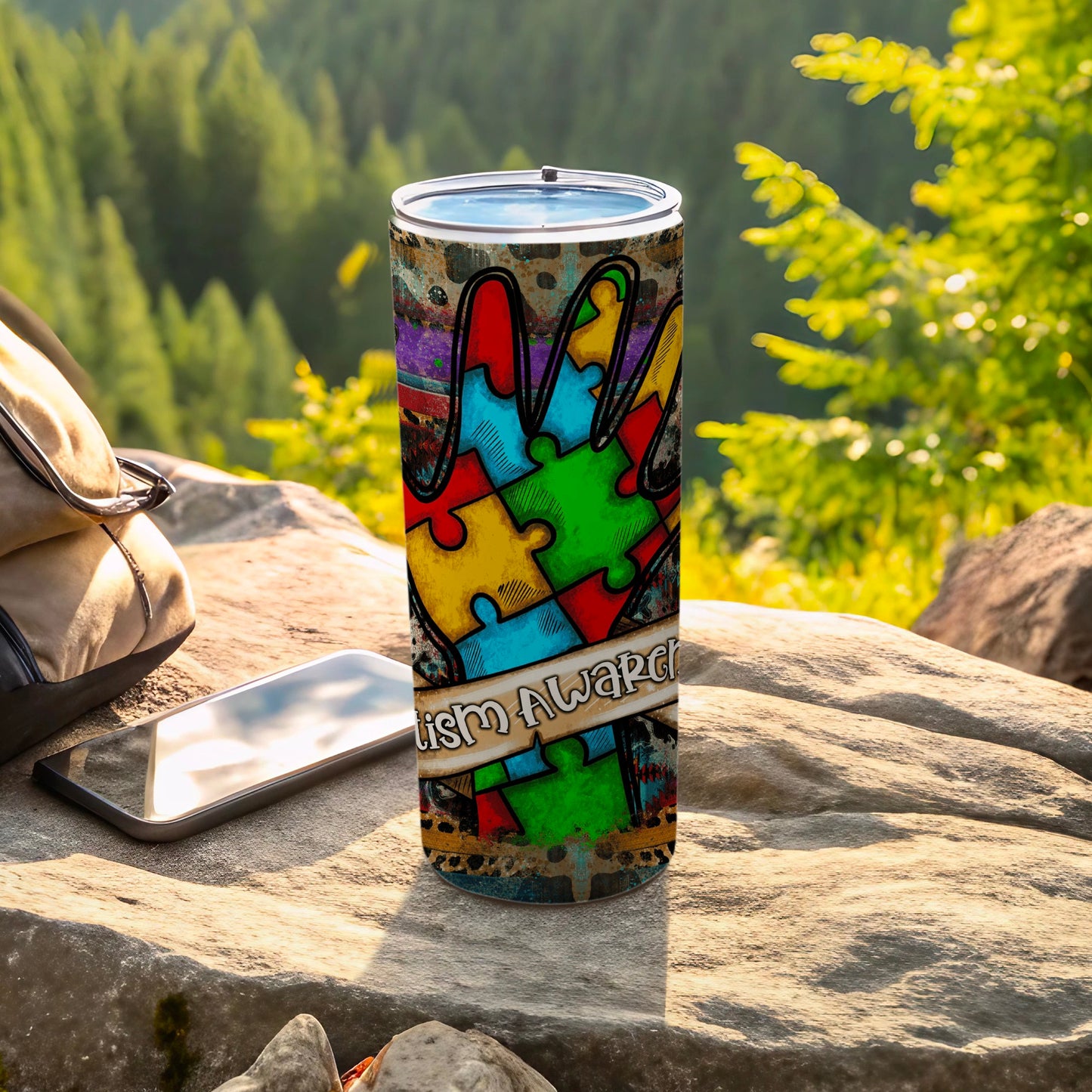 Tumbler with colorful puzzle pieces and "Autism Awareness" ribbon.