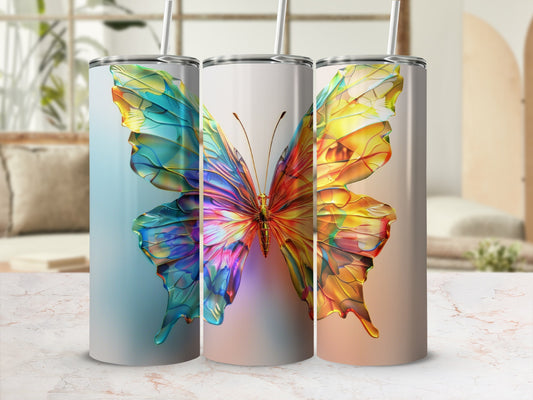 Three tumblers with iridescent butterfly wings, one in front of two behind.