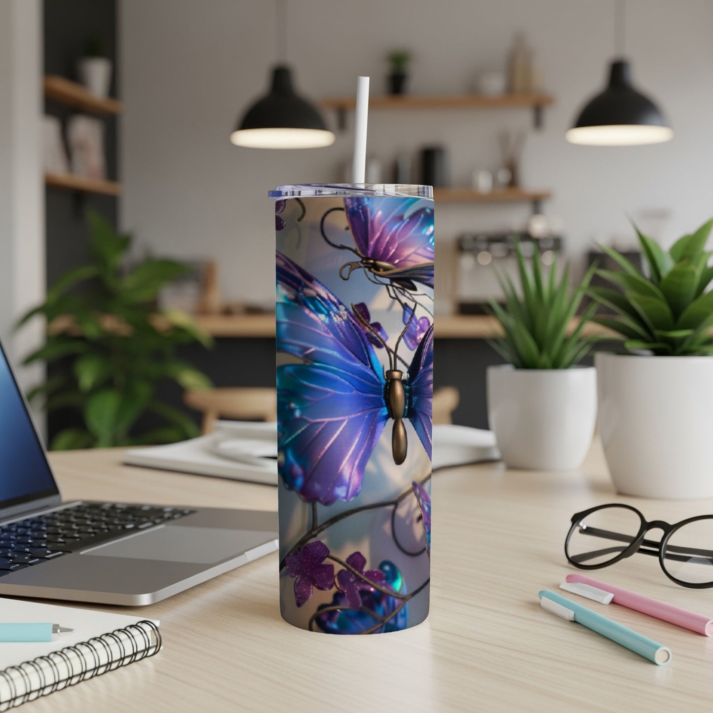 Purple and blue butterflies on a metallic tumbler with a straw.