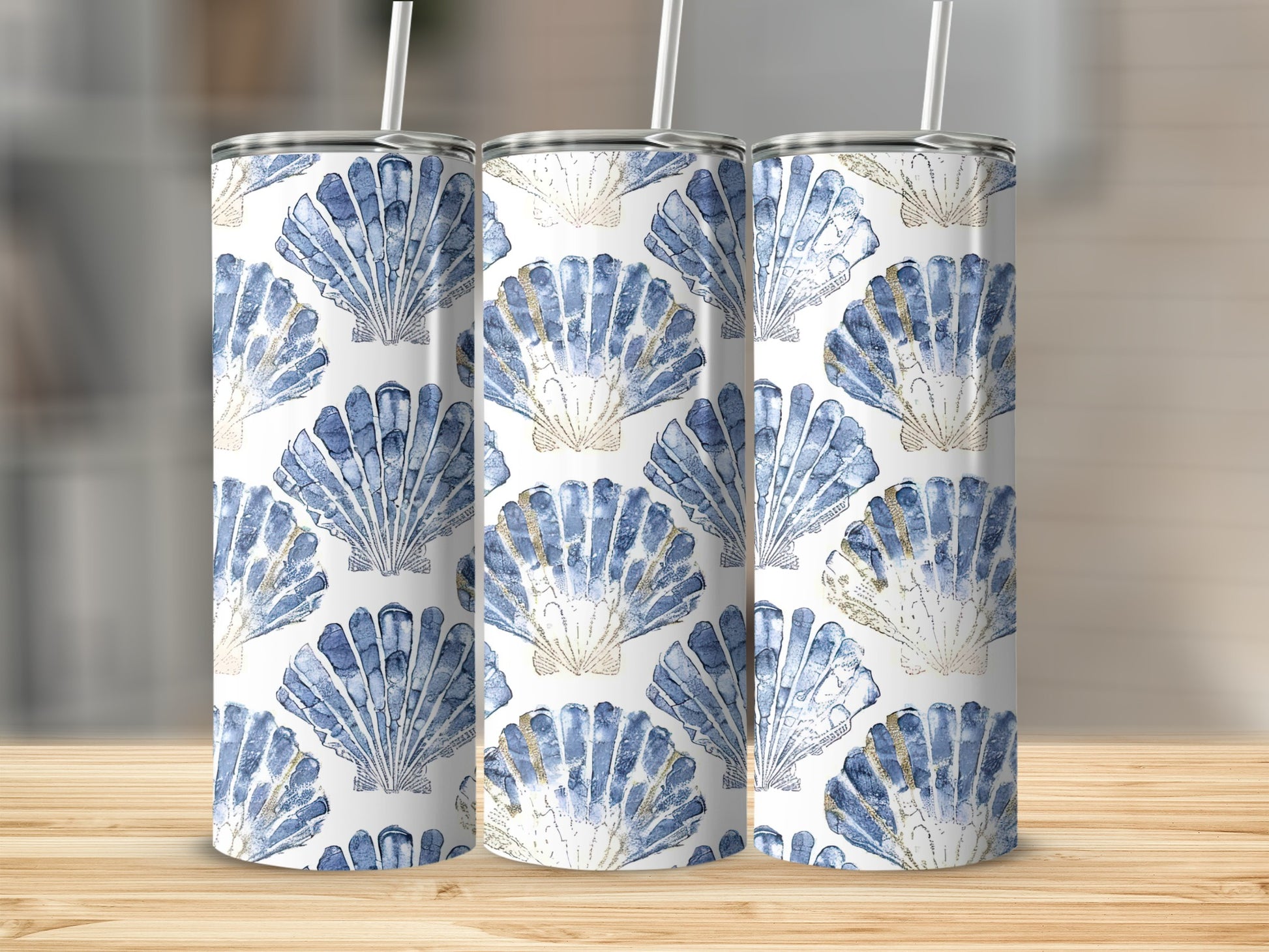 Three tumblers with a blue and gold seashell pattern.