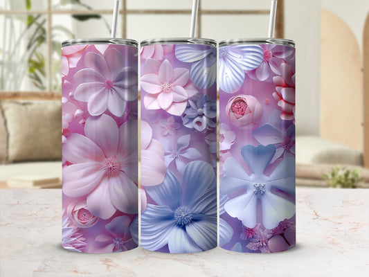 Three tumblers with pink and blue floral designs and straws.
