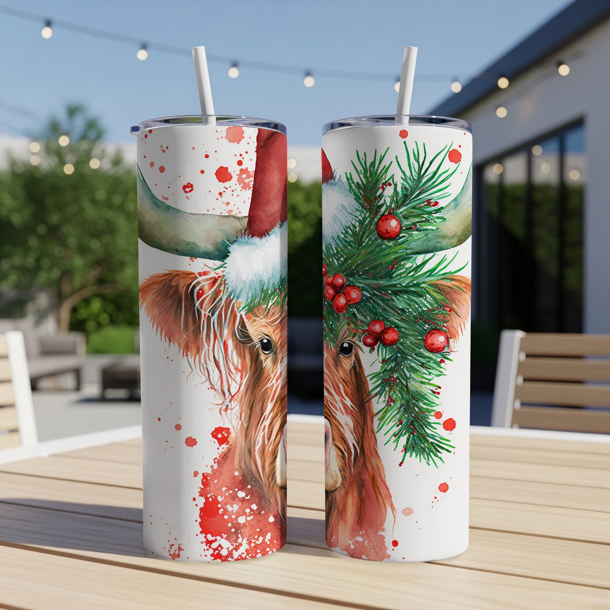 Watercolor Highland cow in Santa hat with pine boughs and berries on a tumbler.