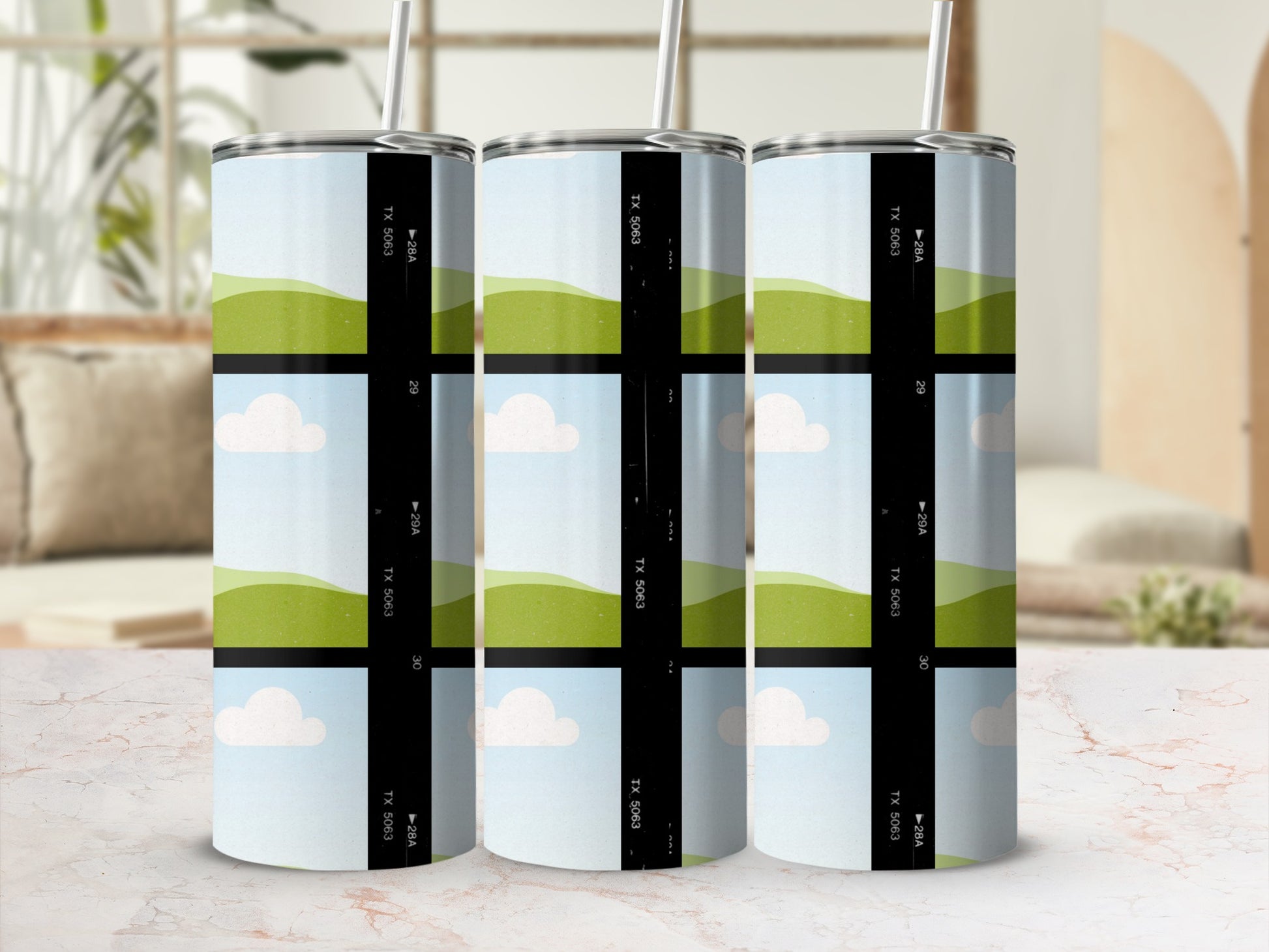 Three tumblers with a film strip design featuring rolling green hills and clouds.