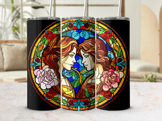 Two women's faces in stained glass pattern on a black tumbler.