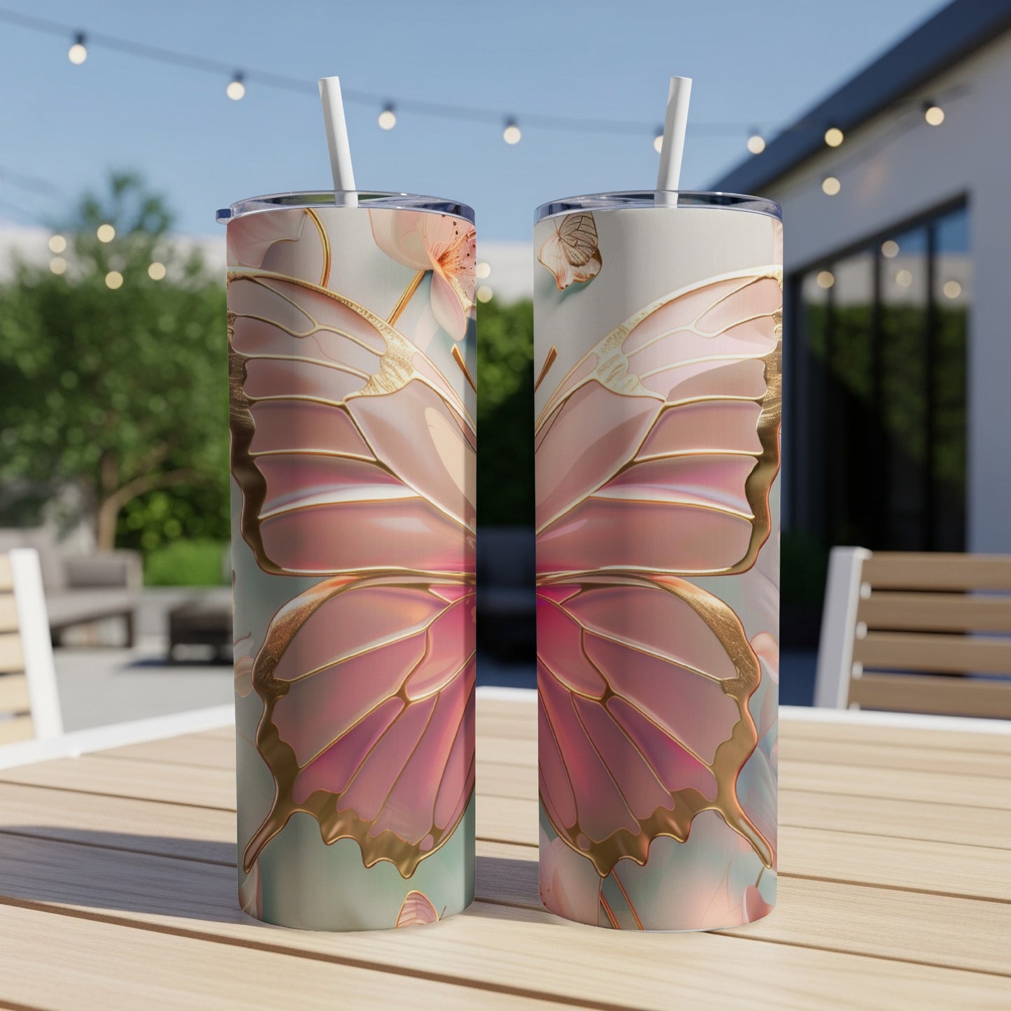 Two tall, skinny tumblers with large pink and gold butterfly wing designs.