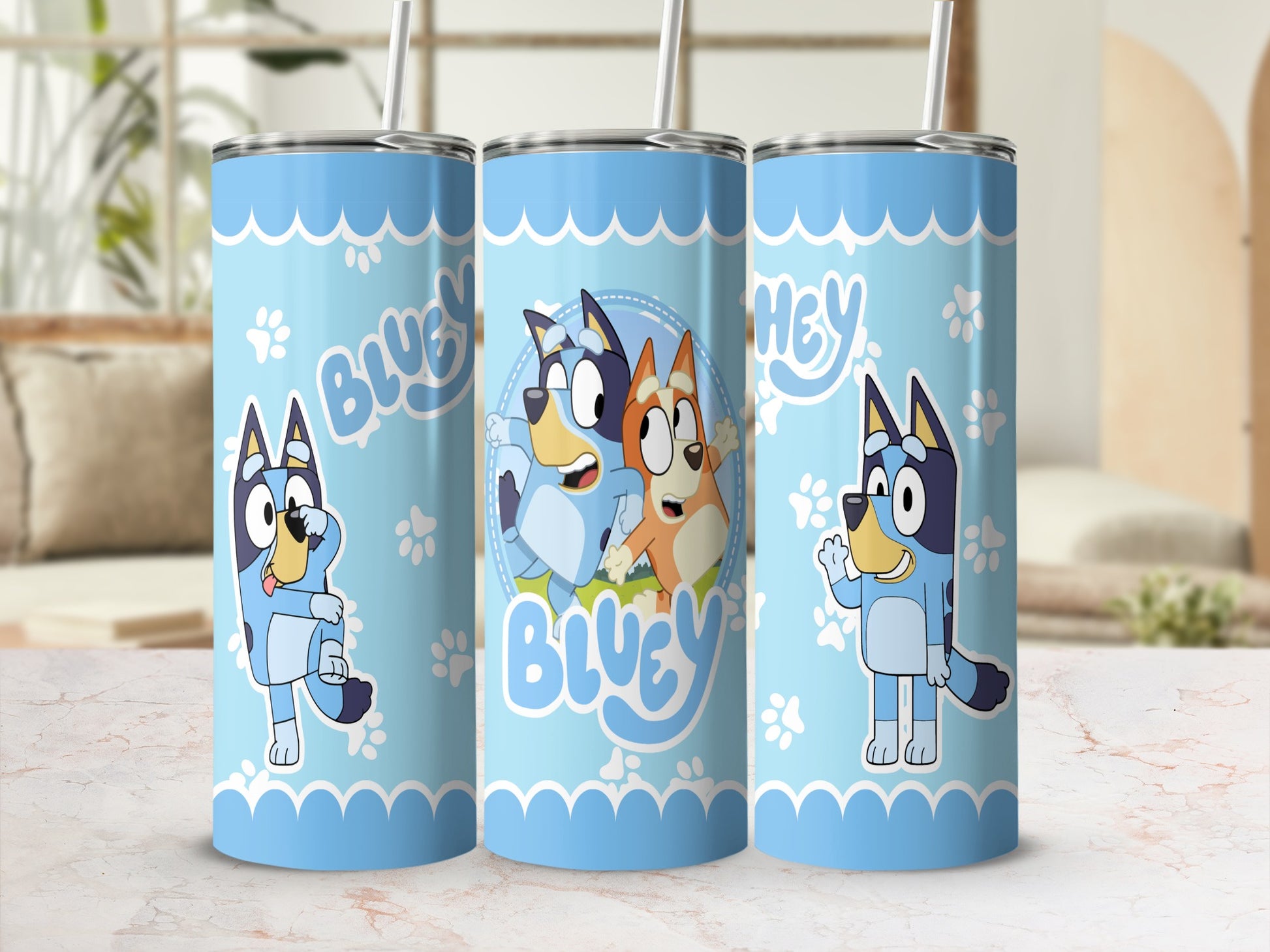 Bluey and Bingo characters on a light blue tumbler with playful wavy patterns.