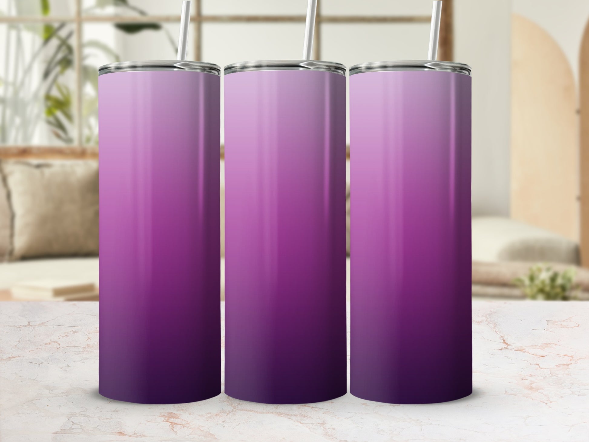 Three purple gradient tumblers with straws on a marble surface.