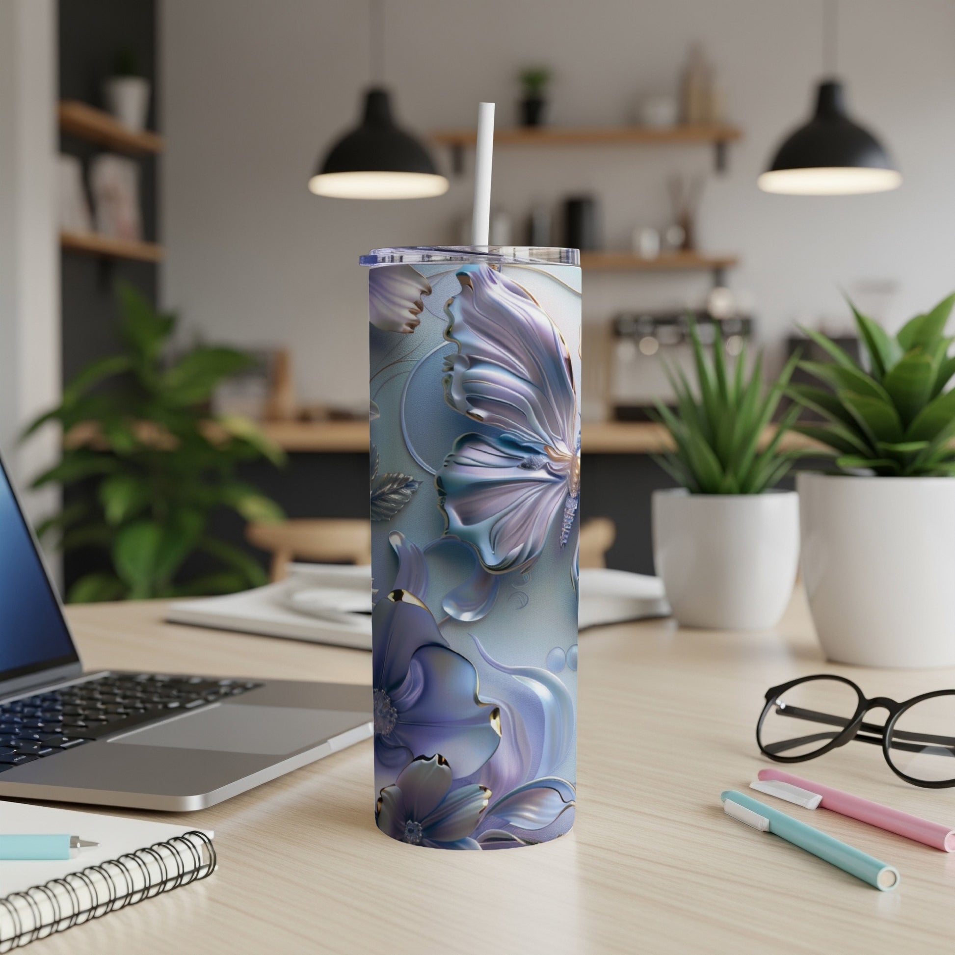 Purple floral tumbler with straw on a desk.
