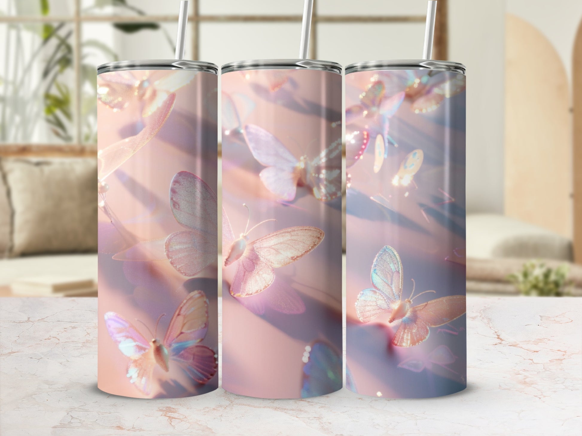 Three iridescent butterfly tumblers with straws, arranged in a row.