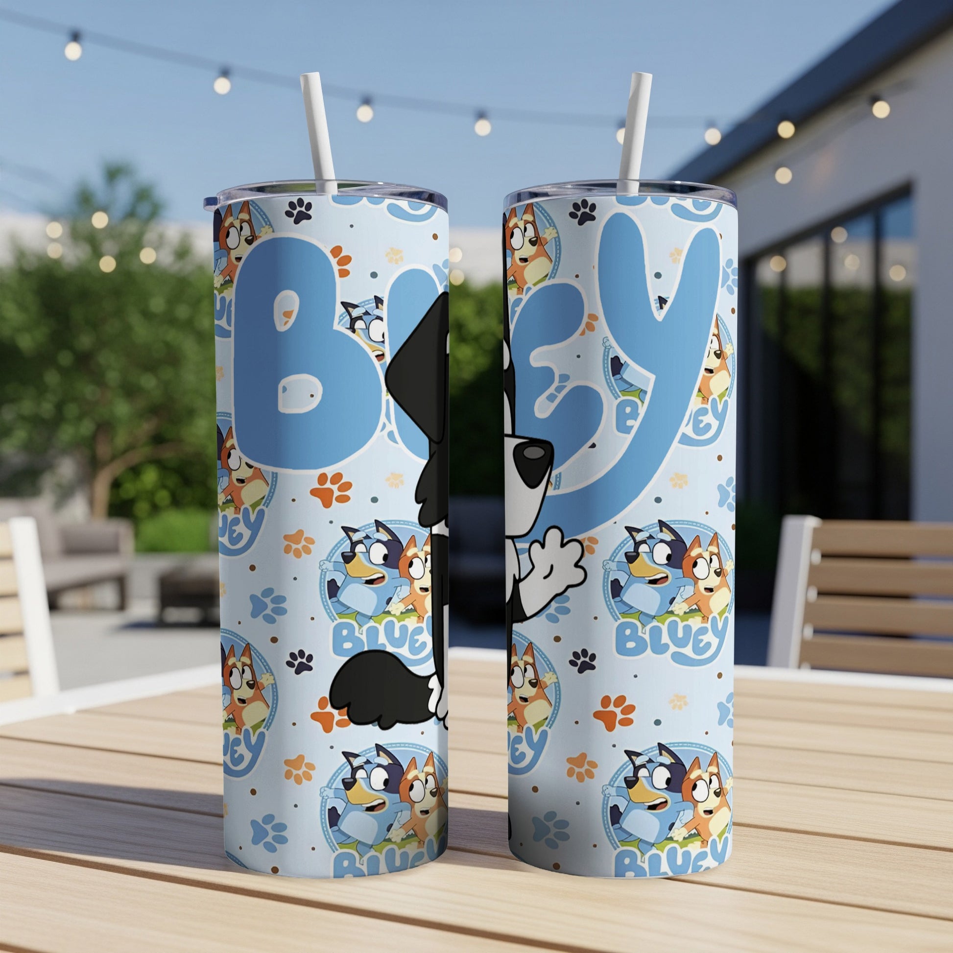 Bluey and Bingo cartoon characters on a blue patterned tumbler with straw.