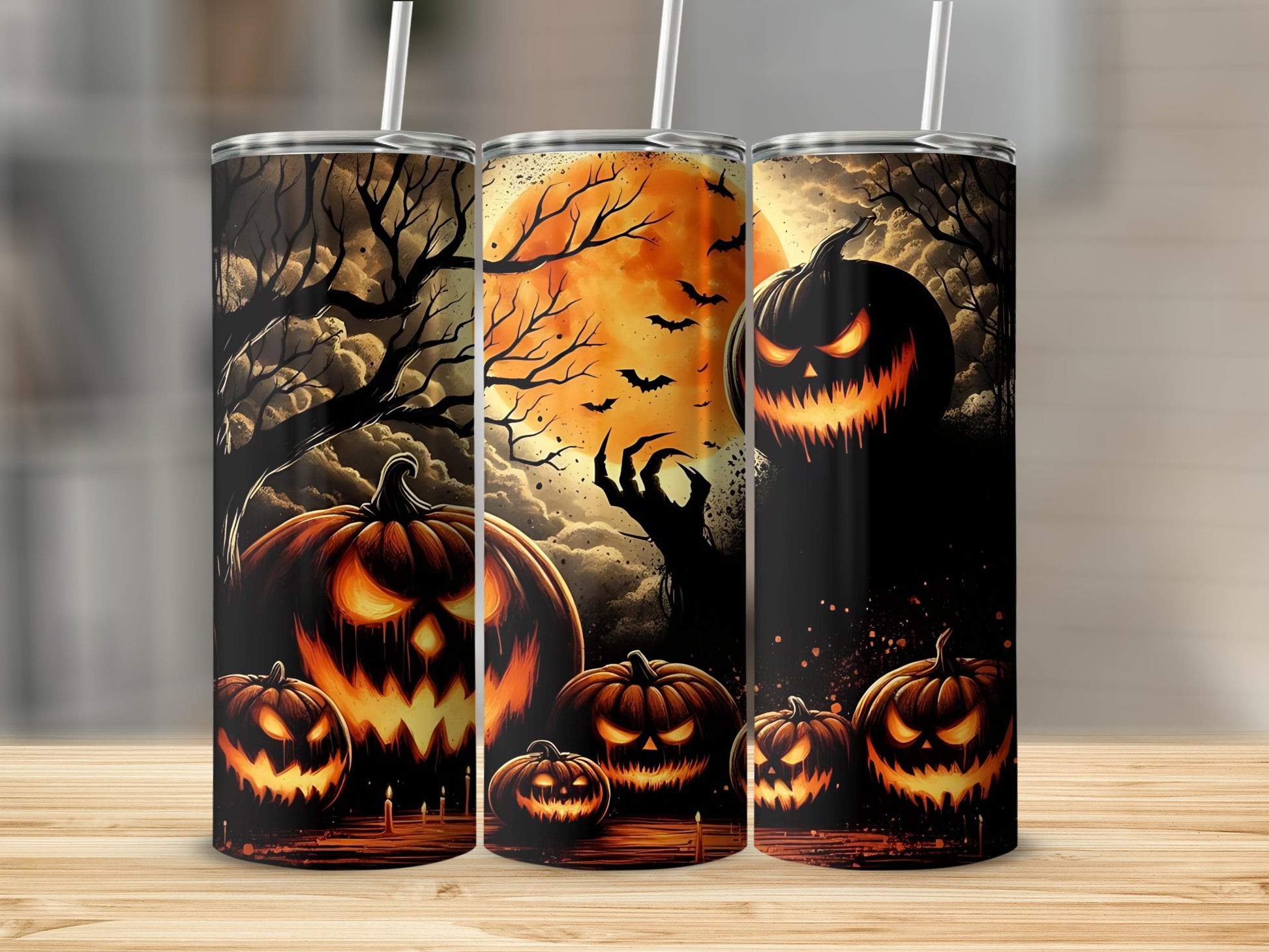 Three tumblers with spooky Halloween jack-o'-lanterns and eerie trees against a large moon.