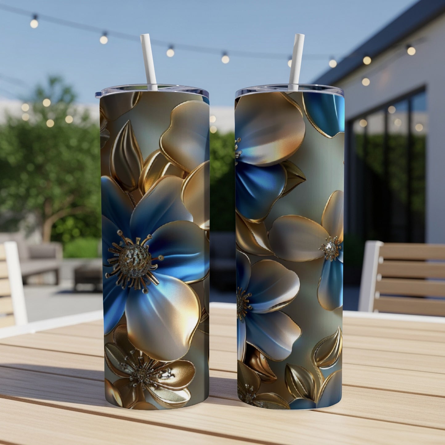 Two tumblers with blue and gold floral pattern on a table.
